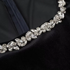 Detail of velvet dress collar with sparkling rhinestone embellishments and hidden back zipper