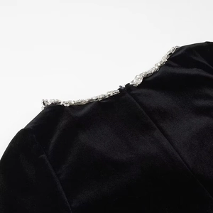Detailed view of black velvet dress back collar with silver rhinestones and invisible zipper