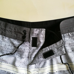 Quick-dry men's swim trunks with grey splash pattern and drawstring waist detail