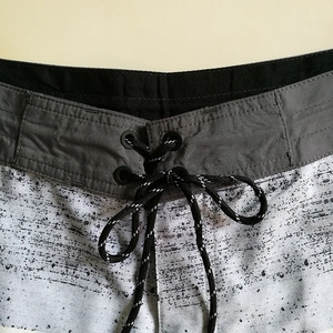 Quick-dry men's beach shorts featuring a drawstring waist and black marble texture