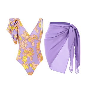 Detail of floral one-piece swimsuit with ruffled neckline and sheer lavender sarong