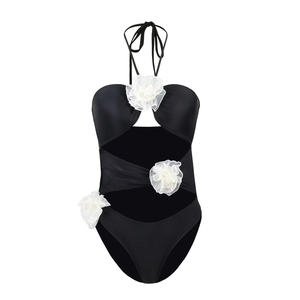 Detail of 3D white fabric flowers on black cut-out one-piece swimsuit for women