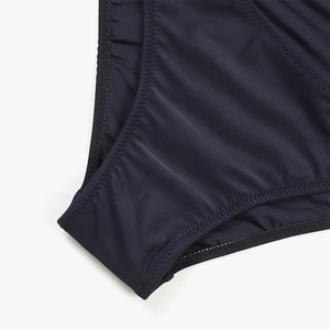 Close-up of black swimwear showing high-elasticity fabric and reinforced zig-zag stitching