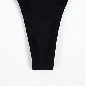 Detail shot of the reinforced black elastic fabric stitching on the bikini bottom