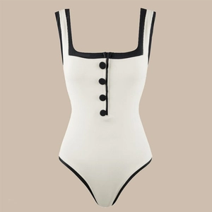 Close-up of contrast black binding and decorative buttons on ivory square neck swimsuit