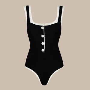 Detail showing high-quality ribbed fabric and white decorative buttons on the swimsuit