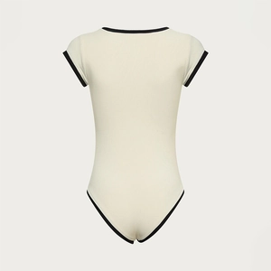 Detail of off-white ribbed knit bodysuit with black contrast piping on sleeves and neck