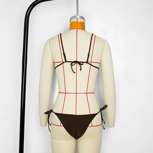 Detail view of deep brown bikini set with back-tie closure on a mannequin stand