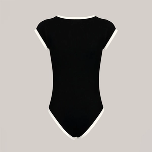 Detail of ribbed knit texture on a one-piece swimsuit with black and white contrast piping