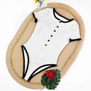 Detail of white ribbed bodysuit with black trim and buttons on woven mat background