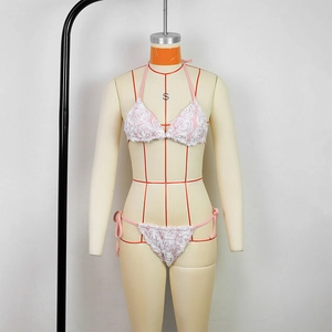 Detailed macro of pink bikini with 3D white rose petal appliqué and textures
