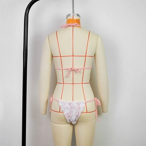 Detail of pink bikini bottoms with a large white 3D floral rose applique on the back