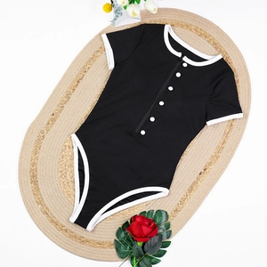 Flat lay of a black ribbed short-sleeve bodysuit with white trim and zipper details