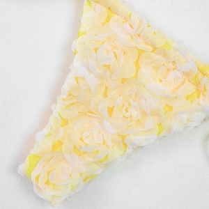 Detail of 3D yellow floral lace fabric with intricate mesh for trendy bikini swimwear