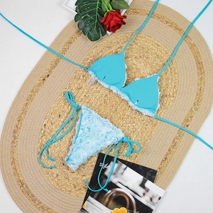 Detail of blue bikini with white lace trim and 3D floral texture rose decorations
