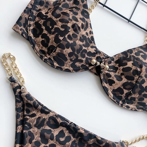 Detail of leopard print bikini top with gold chain straps and metallic studs