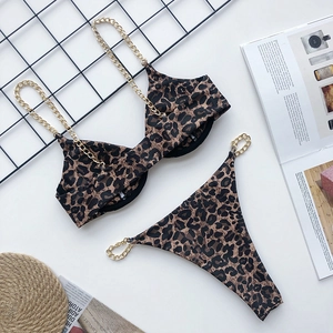 Detail of leopard print bikini set with stylish gold chain straps and metal hardware