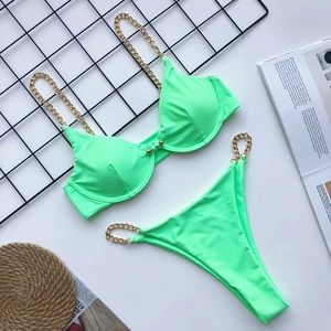 Close-up of neon green bikini with gold metal chain straps and underwire support