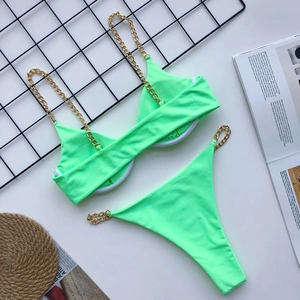 Detail of neon green chain bikini set showing golden chain straps and wired bra cup