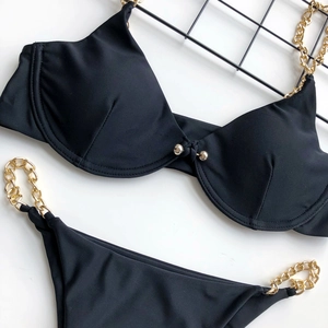 Detail of sexy black chain bikini with gold link straps and underwire support cups