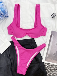 Flat lay of rose red ribbed bikini set with wide straps and high cut bottoms