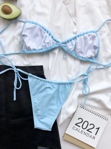 Flat lay of light blue string bikini set with adjustable ties and ribbed texture fabric