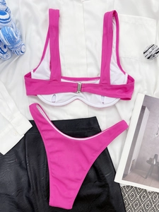 Flat lay of pink ribbed two-piece bikini featuring metal back buckle and wide straps