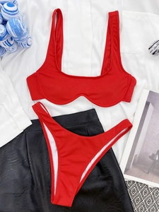 Detailed flat lay of red ribbed bikini featuring underwire support and textured fabric