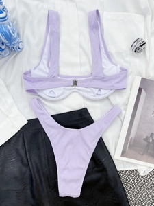 Flat lay of ribbed lilac bikini set with metallic back buckle and high-cut bottom