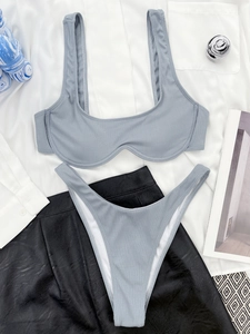 Detailed flat lay of a blue-grey ribbed bikini set with stylish vertical stripe texture