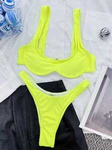 Neon green ribbed bikini set displayed on stylish fashion background with white shirt
