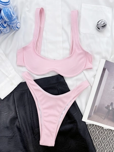 Flat lay of pink ribbed bikini set with high-cut bottoms and textured fabric detail