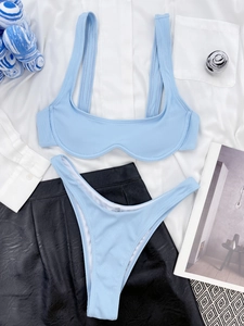 Detailed flat lay of light blue ribbed bikini showing textured fabric and U-shaped top