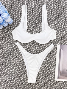 Detailed close-up of white ribbed fabric texture on a two-piece bikini swimsuit