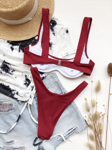 Flat lay of wine red ribbed bikini set with underwire top and metal back clasp detail