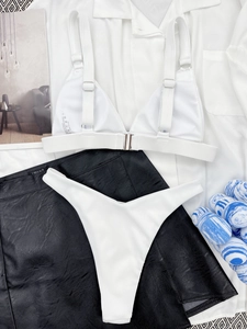 Close-up of white ribbed bikini set with metal front buckle and adjustable straps