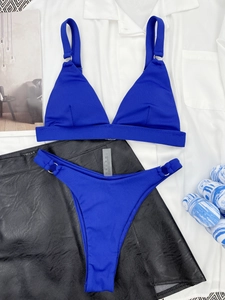 Detail of royal blue ribbed bikini top featuring metallic silver ring on shoulder strap
