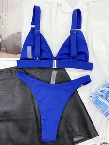 Detail of royal blue ribbed bikini set with silver metal buckles and fabric tag