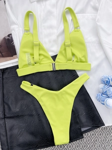 Detail of ribbed lime green bikini top with metal ring connector and adjustable straps