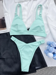 Close-up of mint green ribbed fabric texture on a two-piece bikini set