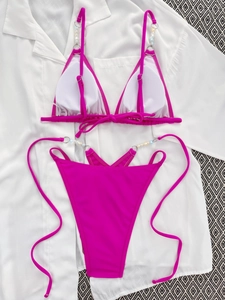 Detail of rose red bikini set with white pearl beads on adjustable shoulder straps