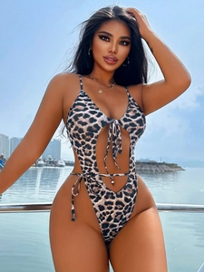 Detail of sexy leopard print swimsuit with hollow-out design and lace-up straps on a yacht