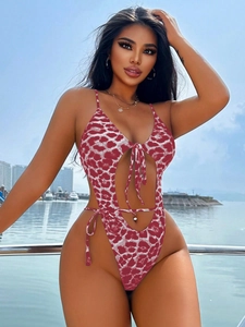 Detail of red and white leopard print one-piece swimsuit with cutout and lace-up design