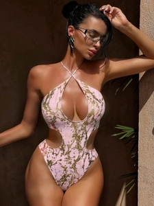 Detailed view of pink halter swimsuit with golden snake texture and side cut-outs