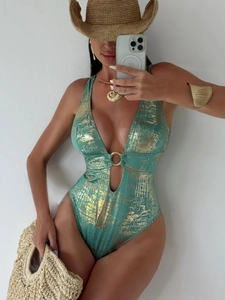Close-up of mint green swimsuit featuring metallic gold foil texture and a gold ring detail