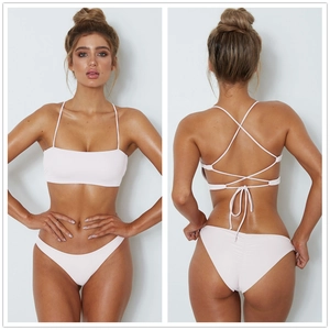 Front and back view of a white strapless bandeau bikini set with crossover straps