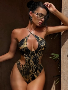 Macro shot of snakeskin texture on a sexy cutout monokini with warm outdoor lighting