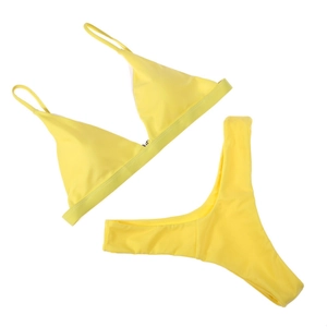 Detailed flat lay of a bright yellow triangle bikini set with high-cut T-back bottoms