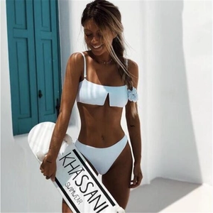 Detail shot of white two-piece bikini with thin straps and V-cut neckline on a model
