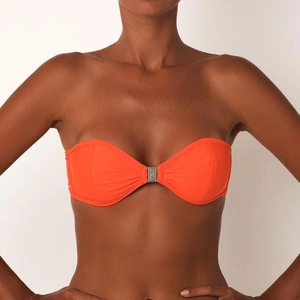 Detailed view of an orange bandeau bikini top featuring a center silver metal ring buckle